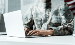 military man working at laptop