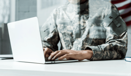 military man working at laptop
